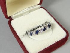 A white gold sapphire and diamond baguette full-hoop eternity ring, size P, 3.28 gms