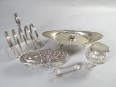 An oval silver inkstand on four supports with centre facet cut-glass bottle with silver hinged