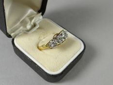 An 18ct three stone diamond abstract ring