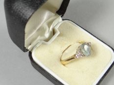 An 18ct yellow gold aquamarine and diamond seven stone ring