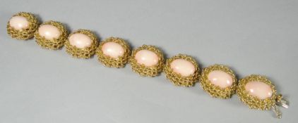 A fine quality angel-skin coral bracelet, each of the eight cabochon corals enclosed in an