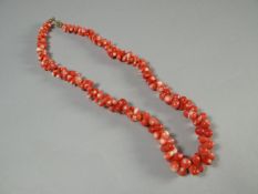 A natural pink coral necklace, 16 ins long