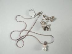 A 925 silver snake necklace with pearl pendant, 8.3 gms; together with a silver bow pin with