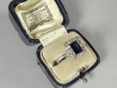 A platinum ring with square cut sapphire surrounded by tiny diamonds, 4.1 gms