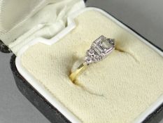 An 18ct yellow gold diamond ring with centre square-cut diamond and further smaller stones to the