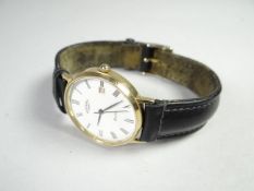 A modern 9k yellow gold encased ROTARY ELITE wristwatch on leather strap