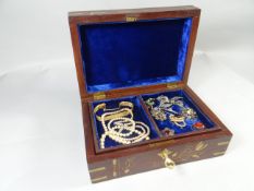 A brass inlaid rosewood jewellery box with contents including marcasite brooch, silver brooches,