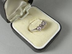 An 18ct white gold and platinum three stone diamond ring