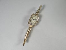 A 1920s 9ct yellow gold wristwatch having an Art Deco dial and expanding bracelet, 14.5 gms total