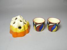 A Clarice Cliff posy-holder in the Fantasque range and two hand-painted Newport pottery egg cups