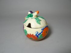 A Clarice Cliff preserve pot and lid in the Gay Day pattern for the Bizarre range