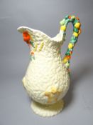 A Clarice Cliff footed jug in the Harvest pattern, 11 ins high (28 cms)