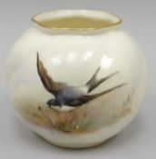 A Royal Worcester blush ivory small globular vase, decorated with a swallow in flight over