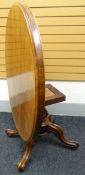 A Victorian mahogany tilt-top oval breakfast table on bulbous carved column and with four sweeping