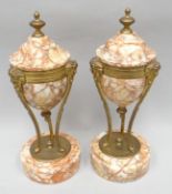 A pair of pink veined marble side-garnitures of urn-form and raised upon three gilt metal figural