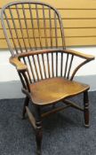 A nineteenth century Windsor elbow-chair with stick and hoop back, shaped arms and on baluster