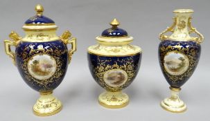 A cream and blue ground Coalport gilded trio with painted countryside scenes by E O Bell, comprising