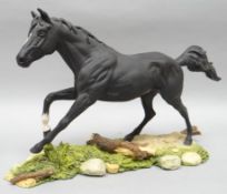 A Royal Doulton horse sculpture of Black Beauty galloping in matt finish on a naturalistic base