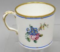 A small Sevres porcelain floral painted and gilded white ground mug