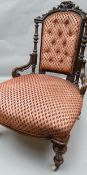 A good Victorian stained open-armchair of elaborate carved form and with classic red diamond-