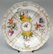 A Meissen pictorial panelled plate of four scenes and with gilt bordering, 7.5 ins diam (19 cms)