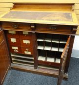 A large turn-of-the-century mahogany clerking-desk having a sloped front above two top drawers on