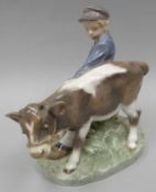 A Royal Copehagen porcelain model of a cap wearing boy struggling to control a grey and white