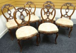 A set of six fine quality Victorian walnut drawing-room chairs with over-stuffed seats and having
