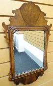 A walnut framed mirror, the arched glass with gilt-slip and shaped frieze, inscribed verso, London