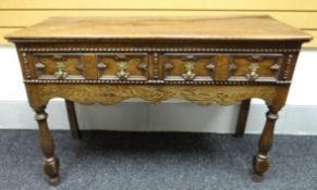 An eighteenth century and later oak two-drawer dresser-base with Jacobean-style geometric moulding
