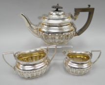 A three piece silver bachelor tea-service of fluted ovoid form, Birmingham 1904, 14.5 ozt gross,