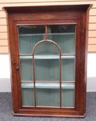 A good nineteenth century Welsh oak hanging-corner cabinet having a single glazed door separated