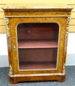 A mid-Victorian figured walnut pier-cabinet, the top with rounded corners, tulipwood cross-banding