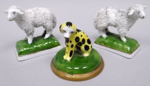 A pair of Chelsea porcelain miniature models of standing sheep on green cushion bases, gold anchor