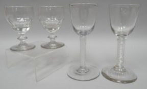 A pair of Georgian air-twist stem glasses with funnel-bowls, 6 ins high (15 cms); together with