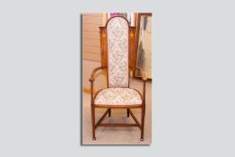 An Art Nouveau mahogany and inlaid highbacked armchair with later upholstered seat and back, the