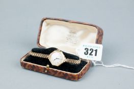A lady's nine carat gold octagonal framed Swiss wristwatch with expanding bracelet in original box