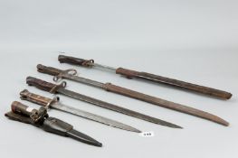 Five various sheathed and unsheathed bayonets, mostly wooden handled, one metal socket bayonet in