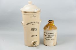 A glazed stoneware Berkefeld water filter complete, 19 ins (48 cms) high and a stoneware flagon