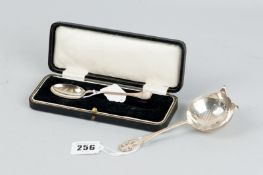 A cased silver spoon, Sheffield 1930 and a silver sugar sifter with pierced and shaped handle,