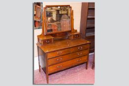 An Edwardian mahogany and line inlaid mirrored dressing chest, 57 x 42 ins (145 x 106.5 cms)