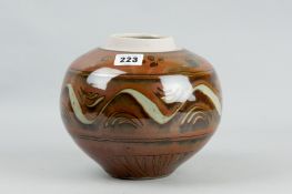 A David Frith circular ginger jar with circular bands of patterns within a brown background in