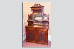 An Edwardian mirror backed sideboard, carved multi-mirrored top over a two drawer and two door