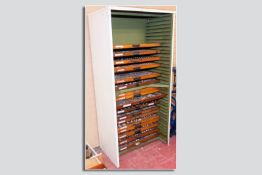 A steel industrial type galley cabinet along with seventeen galley trays/type cases containing a