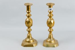 A pair of good sized Victorian brass candlesticks, stamped 'The King of Diamonds', 12.5 ins (32 cms)