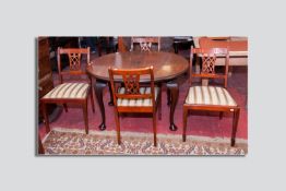 A late Victorian oval mahogany dining table on Queen Anne supports with bun feet and four