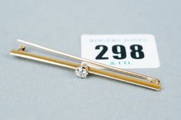 An oblong gold bar brooch, 6 cms long with centre small diamond, visual estimate 0.3 carats, 4.6