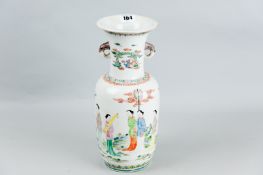 A Famille Rose flared neck vase with elephant head handles, single all-over panel decorated with