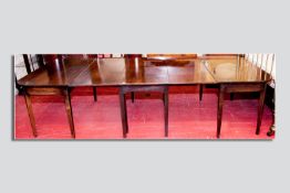 A Georgian mahogany twin D-end dining table with central three leaf gate leg, polished bull nose top