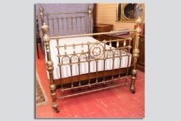 A good Victorian brass bedstead with mother of pearl and copper decorated end brass column and
